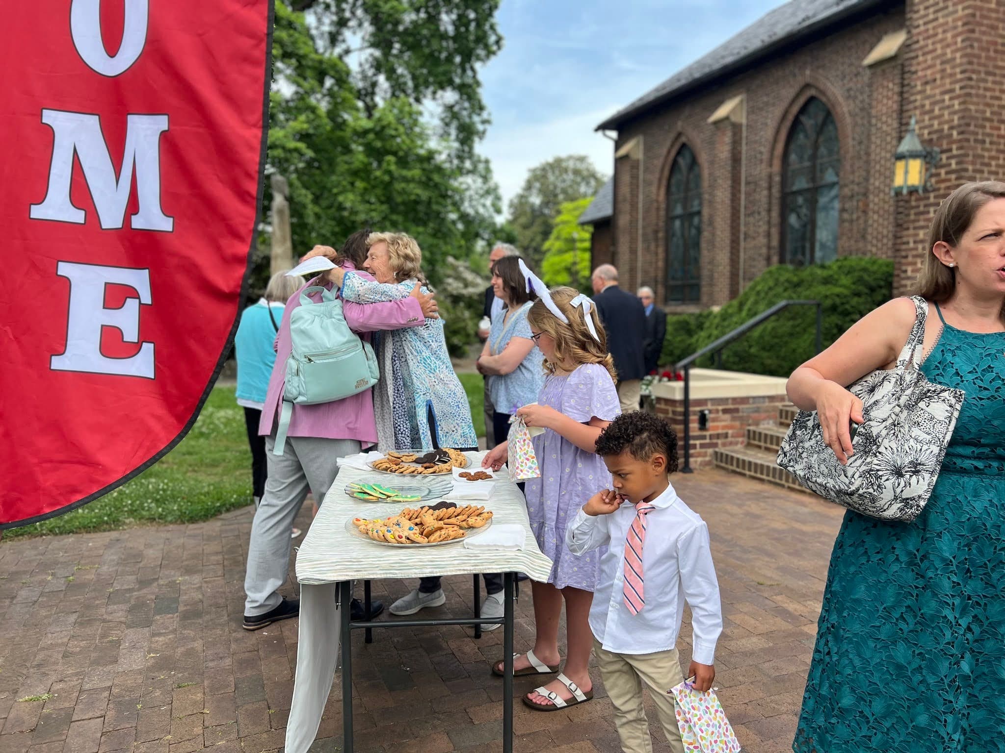 Parishioners and neighbors gathering outside St. Luke's after worship